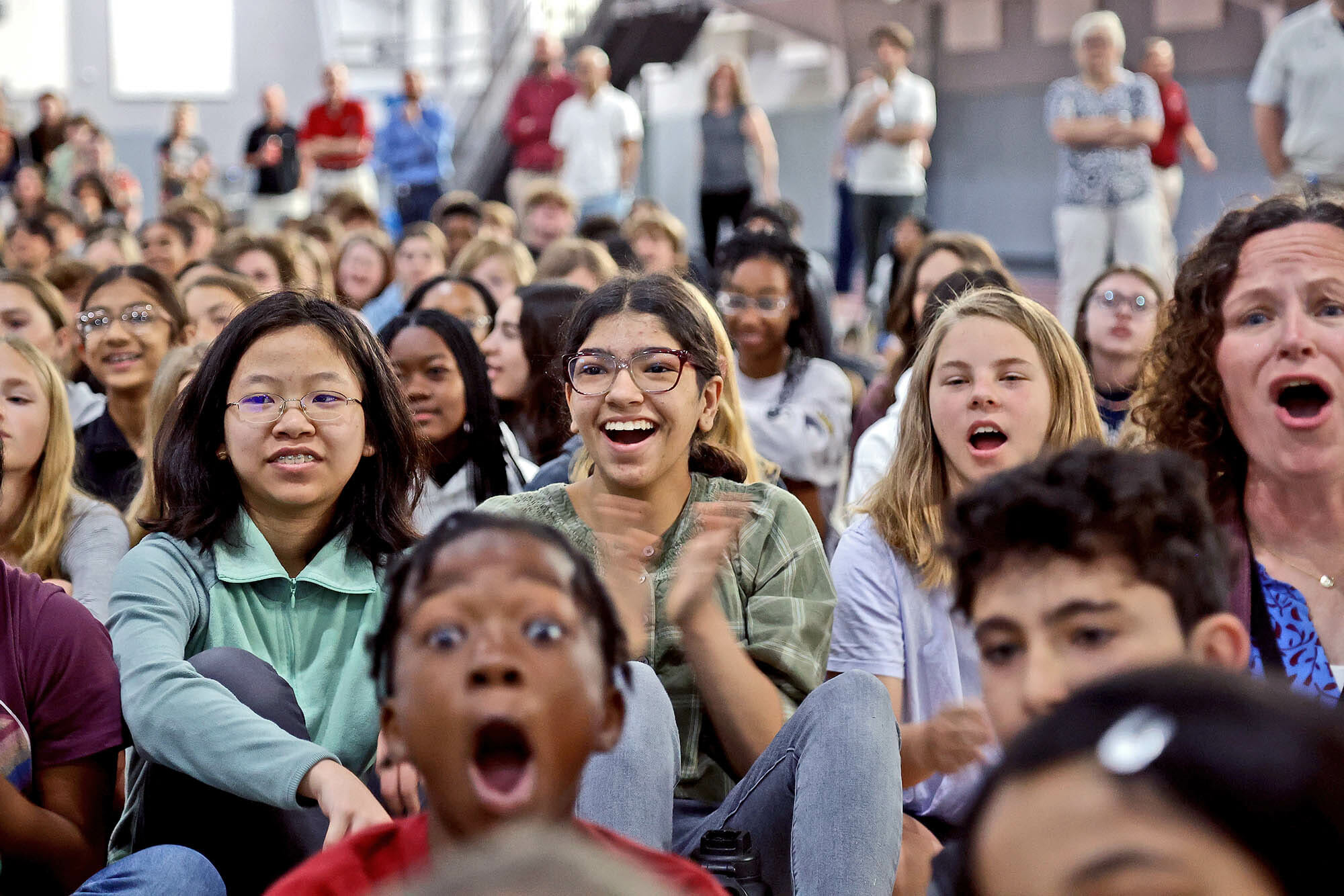 Learners cheering at a school assembly